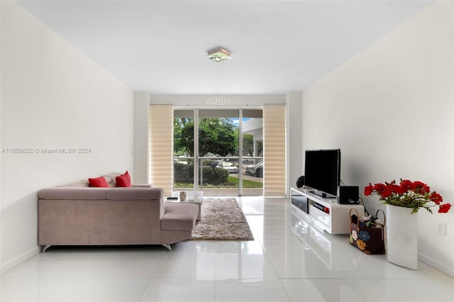 tiled living room with an inviting chandelier