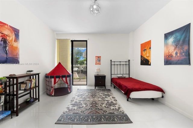 bedroom with access to exterior and tile patterned floors