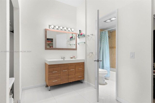 full bathroom featuring vanity, toilet, shower / bath combination with curtain, and tile patterned floors