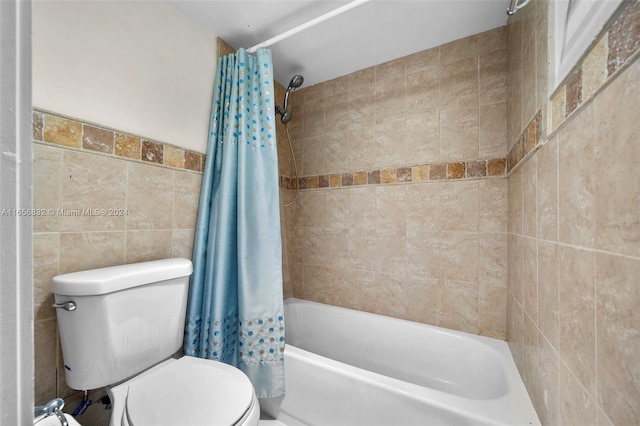 bathroom featuring tile walls, toilet, and shower / tub combo with curtain