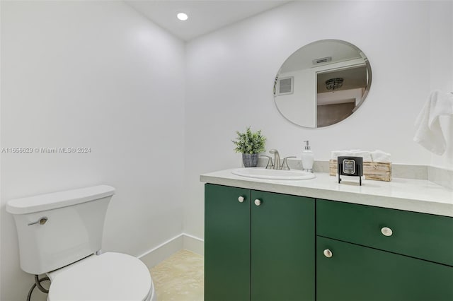 bathroom with vanity, toilet, and tile patterned floors