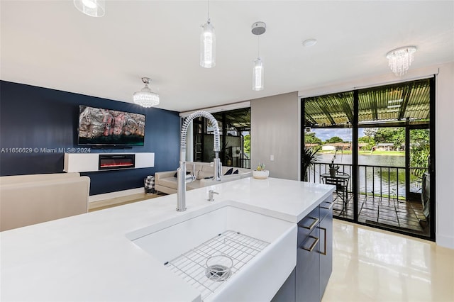 kitchen with a notable chandelier, hanging light fixtures, and sink