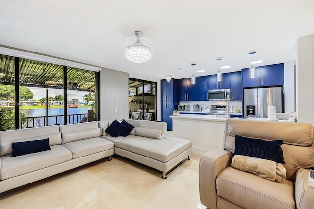 carpeted living room with a chandelier