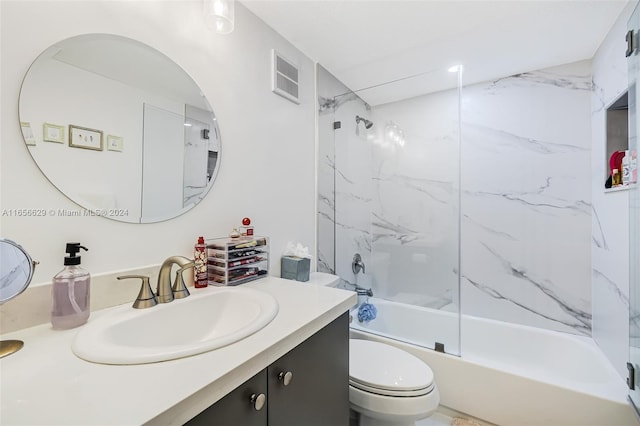 full bathroom featuring vanity, tiled shower / bath combo, and toilet