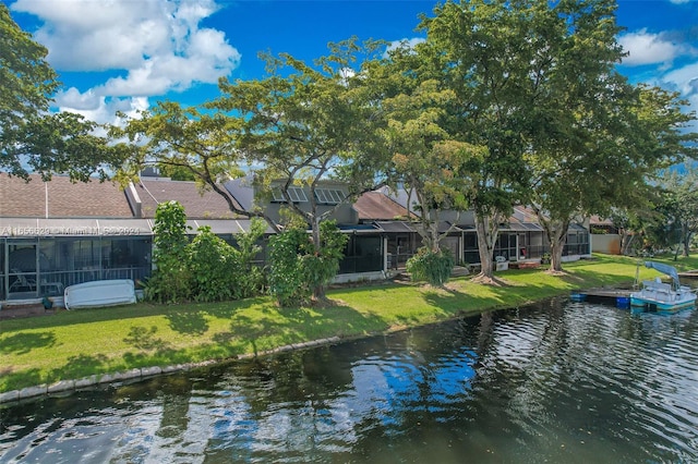 exterior space featuring a lawn and a water view