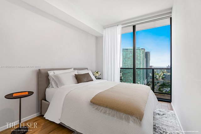 bedroom with hardwood / wood-style flooring