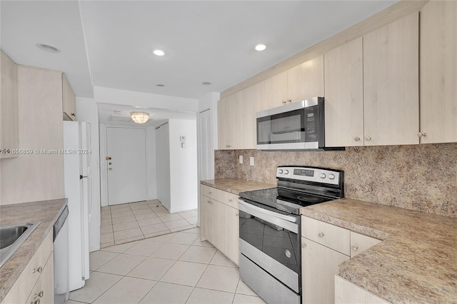 kitchen featuring backsplash, light tile patterned floors, light brown cabinetry, sink, and appliances with stainless steel finishes