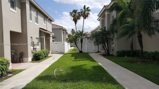 view of property's community with a lawn