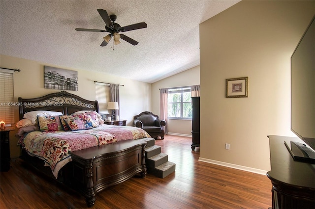 bedroom featuring ceiling fan, vaulted ceiling, a textured ceiling, and hardwood / wood-style floors