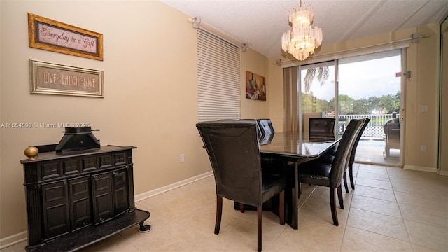 tiled dining room with a textured ceiling and a notable chandelier