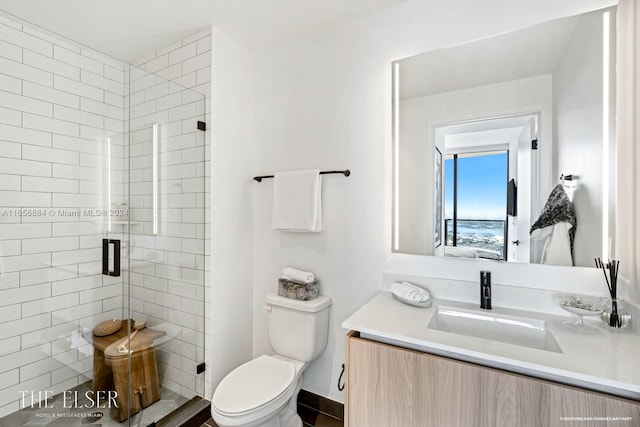 bathroom featuring vanity, toilet, and an enclosed shower