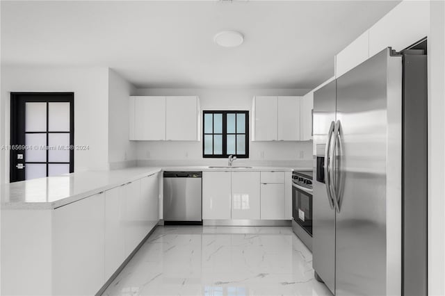 kitchen featuring stainless steel appliances and white cabinetry