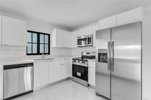 kitchen with white cabinets and appliances with stainless steel finishes