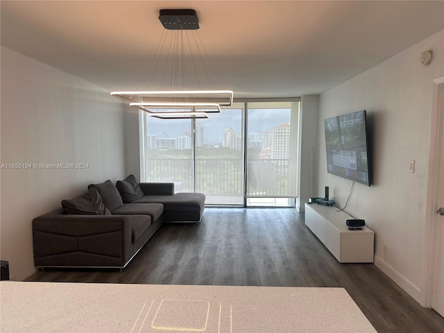 living room featuring dark wood-type flooring and an inviting chandelier