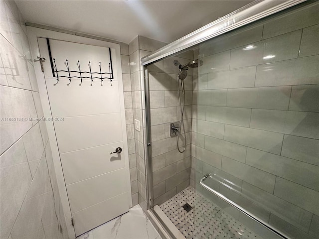 bathroom with a shower with door