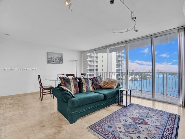 living room with a water view and a wall of windows