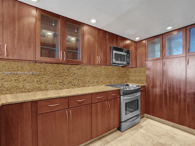 kitchen with tasteful backsplash, light stone counters, and electric range