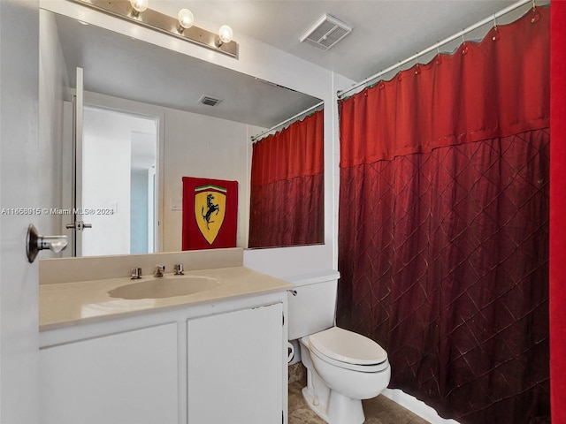 bathroom featuring toilet and vanity