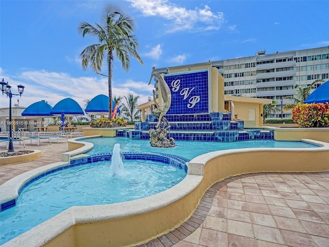 view of swimming pool with pool water feature