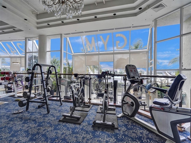 gym with a wall of windows and carpet floors