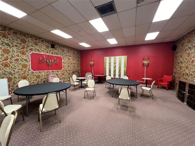 interior space featuring a paneled ceiling and carpet