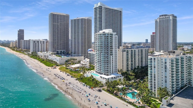 property's view of city featuring a water view and a view of the beach