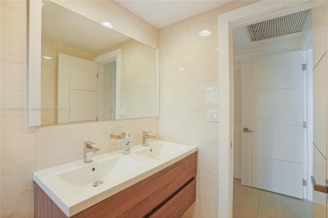 bathroom with tile walls, vanity, and decorative backsplash