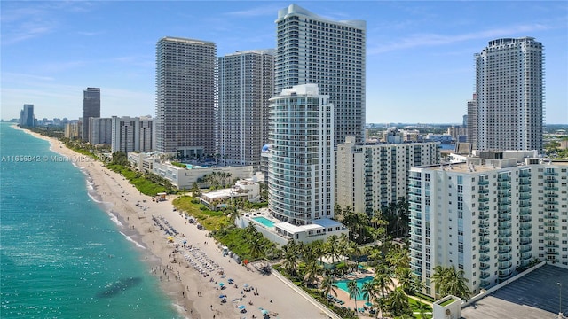 property's view of city featuring a water view and a view of the beach