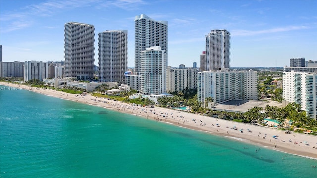 aerial view with a water view and a beach view