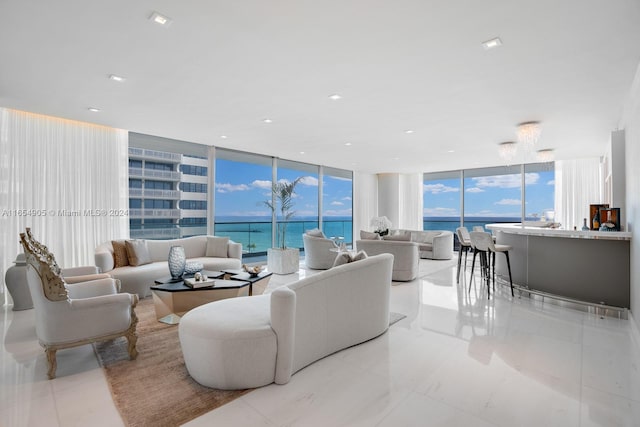 living room with a healthy amount of sunlight, expansive windows, and a water view