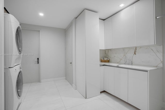 10203 Collins Ave Unit 801, Bal Harbour, FL 33154 - washroom featuring stacked washer / drying machine and light tile patterned floors