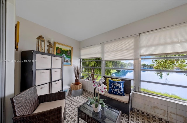 sunroom / solarium featuring a water view