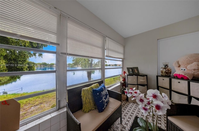 sunroom / solarium featuring a water view and plenty of natural light