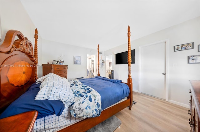 bedroom with light hardwood / wood-style floors and a closet