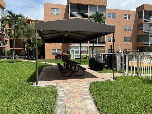 view of home's community with a lawn and a gazebo