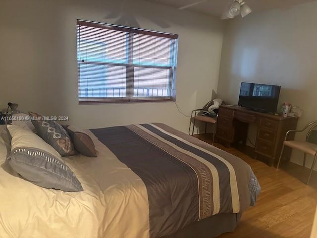 bedroom with hardwood / wood-style floors and ceiling fan