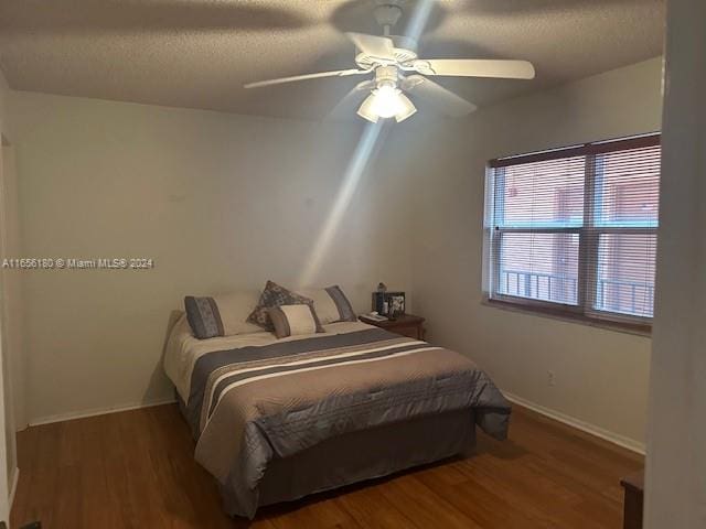 bedroom with dark wood-type flooring and ceiling fan