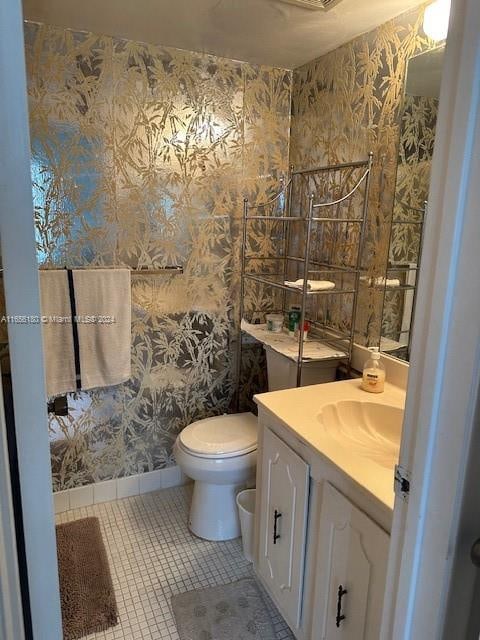 bathroom with vanity, toilet, and tile patterned floors