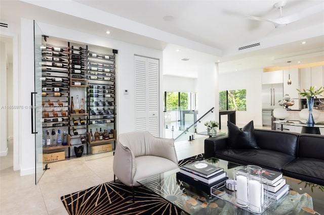 tiled living room with ceiling fan