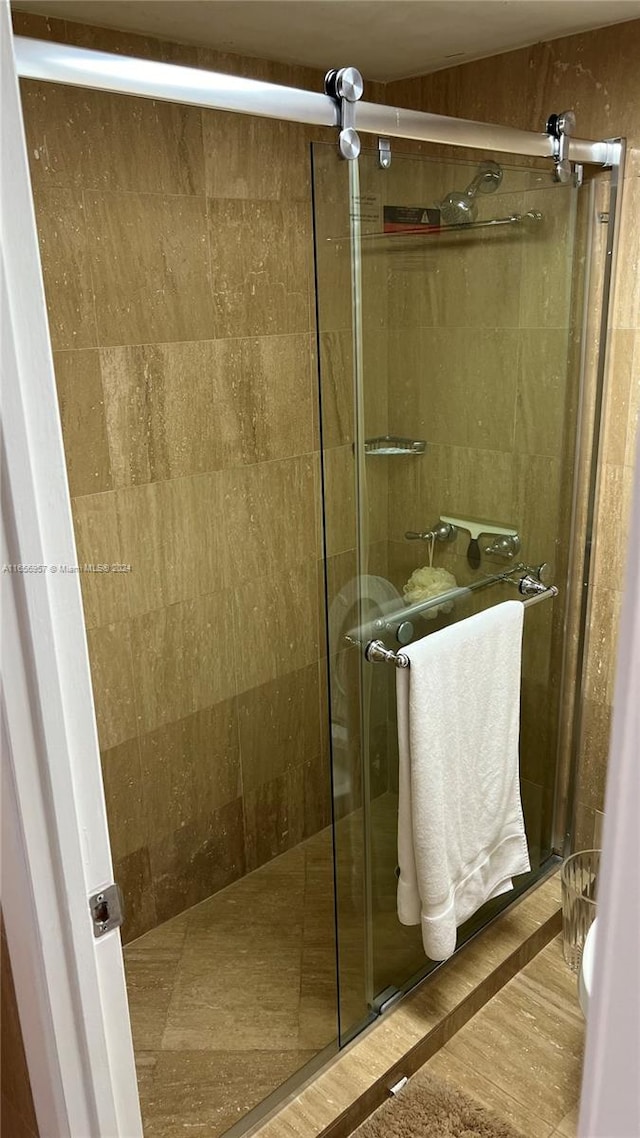 bathroom with a shower with shower door