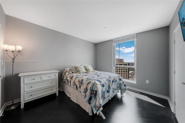 bedroom with dark wood-type flooring