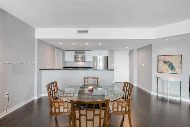 dining space featuring dark hardwood / wood-style flooring