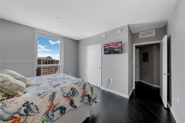 bedroom with dark hardwood / wood-style floors