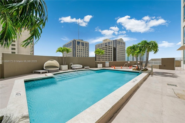 view of swimming pool with a patio area