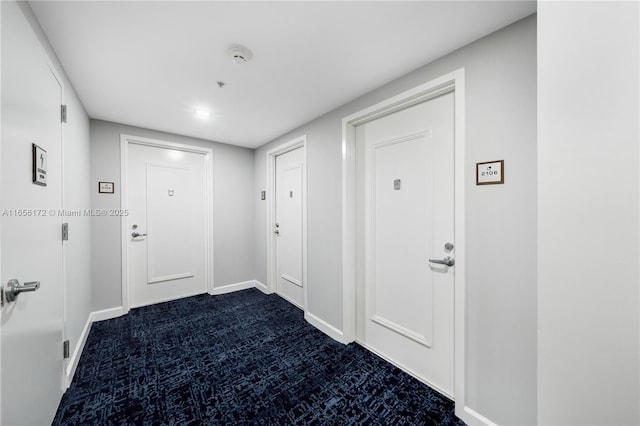 interior space featuring dark colored carpet