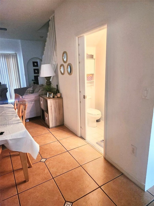 tiled bedroom featuring connected bathroom