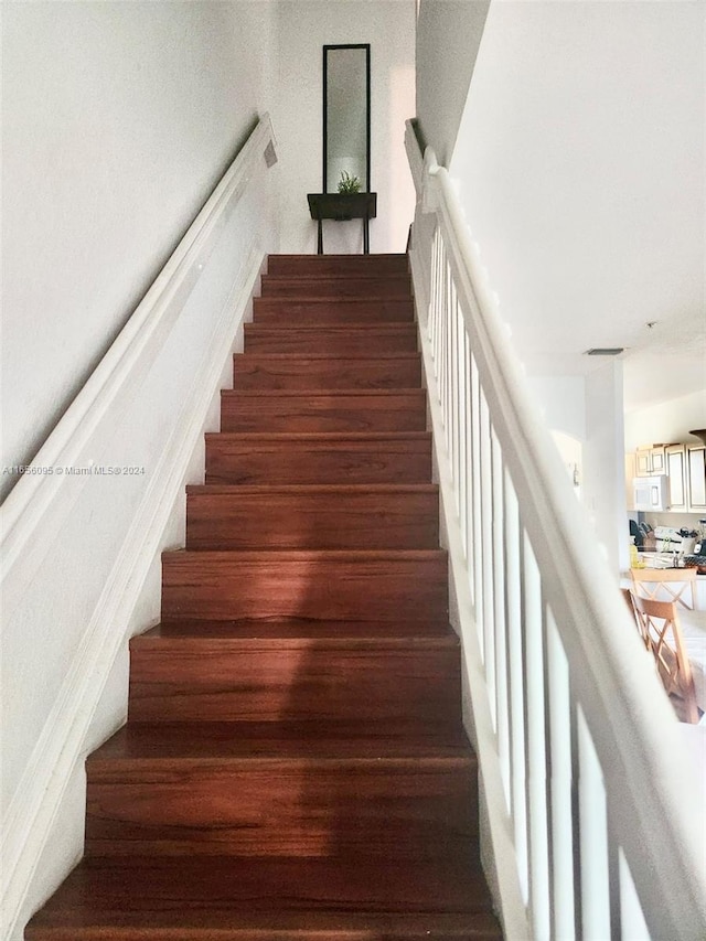 stairway featuring wood-type flooring