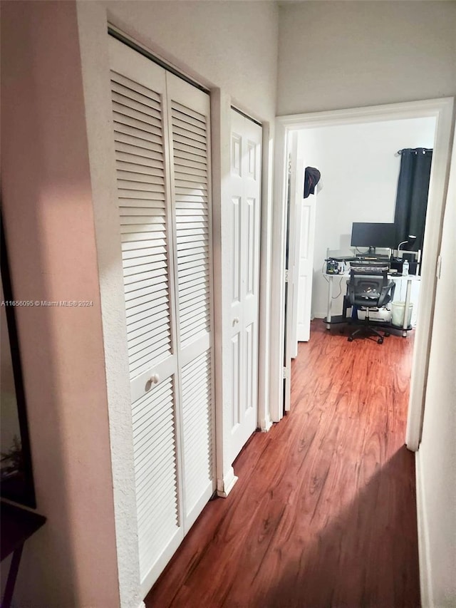 hallway with hardwood / wood-style floors