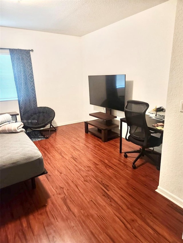 office space featuring hardwood / wood-style floors and a textured ceiling