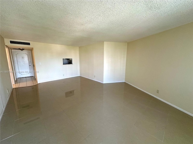 empty room with a textured ceiling